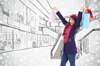 Composite image of brunette in winter clothes holding shopping b