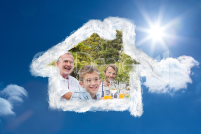 Composite image of laughing family having a barbecue in the park