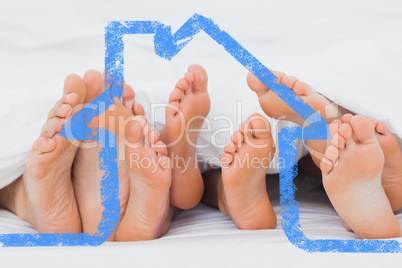 Composite image of feet of family sticking out from the quilt