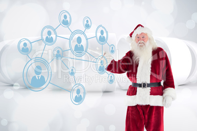 Composite image of santa shows something to camera