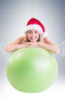 Festive fit blonde posing with exercise ball