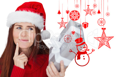 Composite image of redhead holding gift