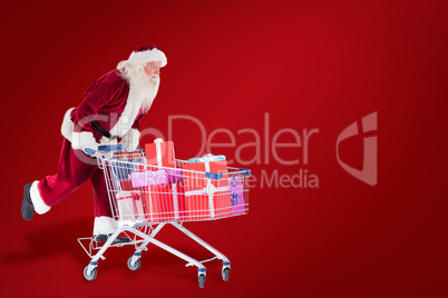 Composite image of santa pushes a shopping cart