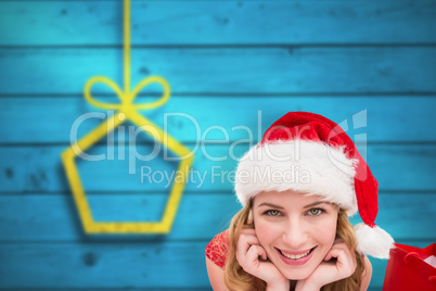 Composite image of smiling woman lying between sale shopping bag