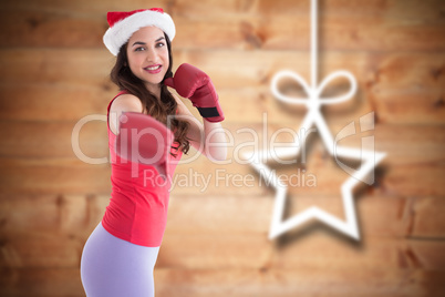 Composite image of festive brunette in boxing gloves punching