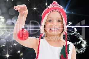 Composite image of cute girl showing bauble