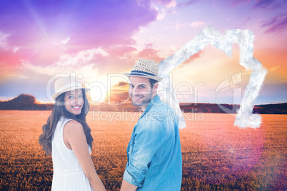 Composite image of happy hipster couple holding hands and smilin