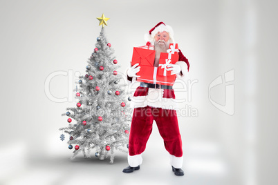 Composite image of santa carries a few presents