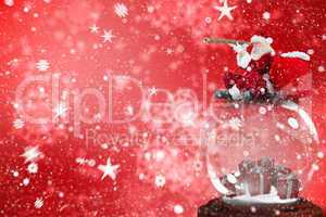 Composite image of santa sitting on snow globe