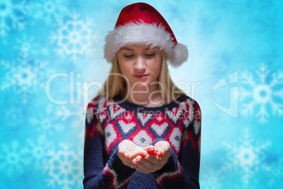 Composite image of festive blonde holding her hands out