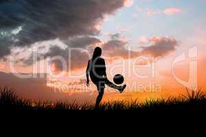 Composite image of cute football player kicking ball