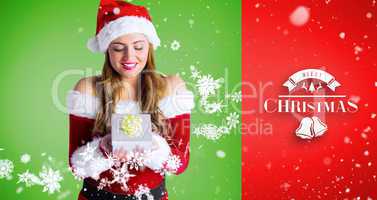 Composite image of pretty girl in santa costume holding gift box