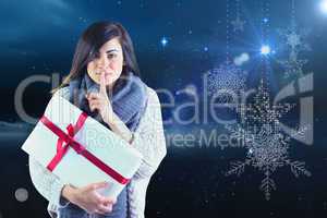 Brunette holding gift and keeping a secret