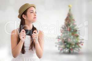 Composite image of happy brunette in hat holding phone