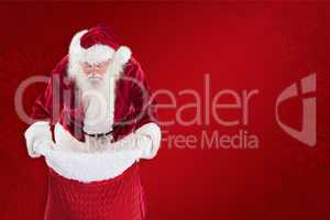 Composite image of santa looks in his bag