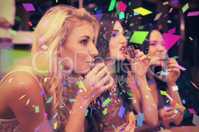 Composite image of happy friends drinking shots together
