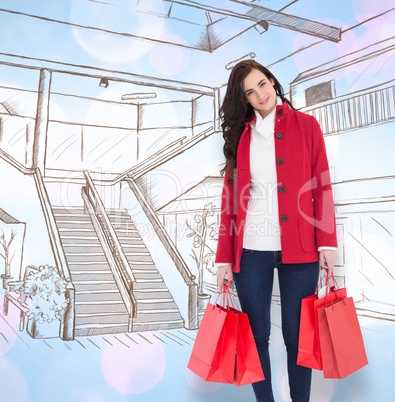 Composite image of smiling brunette in winter clothes holding sh