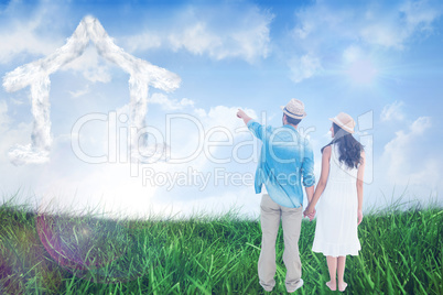 Composite image of happy hipster couple holding hands and lookin