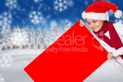 Composite image of festive little girl showing card