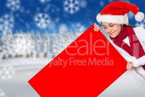 Composite image of festive little girl showing card