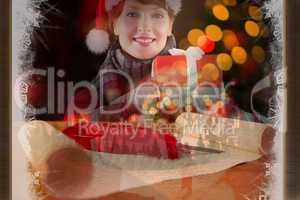 Composite image of smiling woman holding christmas presents