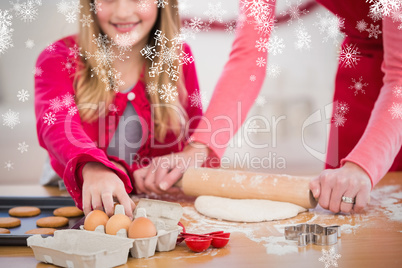 Composite image of festive mother and daughter making christmas