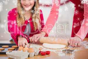 Composite image of festive mother and daughter making christmas