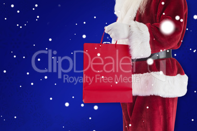 Composite image of santa carries red gift bag