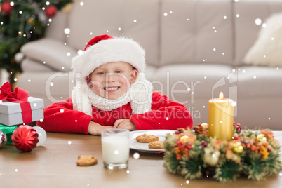 Composite image of festive little boy smiling at camera