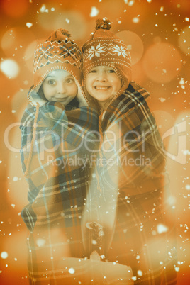 Composite image of festive little girls under a blanket