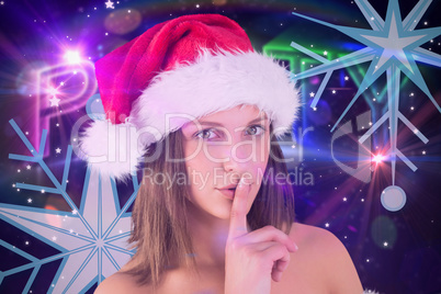 Composite image of festive brunette keeping a secret