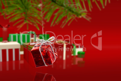 Composite image of red christmas decoration hanging from branch