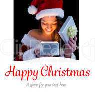 Composite image of pretty brunette in santa outfit opening gift