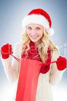 Happy festive blonde with shopping bag