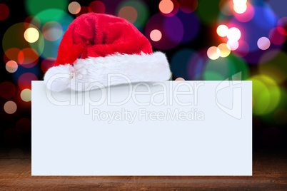 Composite image of santa hat on poster