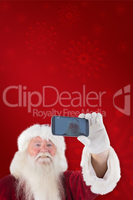 Composite image of santa taking a selfie on phone