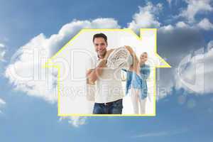 Composite image of smiling couple carrying rolled rug after movi