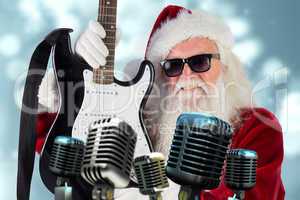 Composite image of father christmas shows a guitar