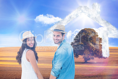 Composite image of happy hipster couple holding hands and smilin