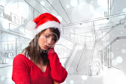 Composite image of sad woman in santa hat holding her head
