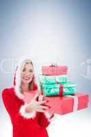 Festive blonde holding pile of gifts