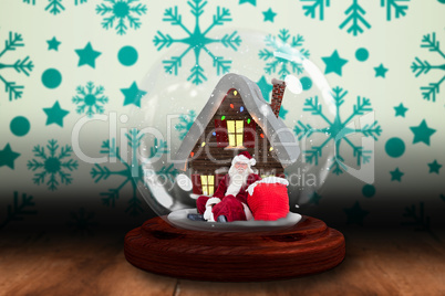 Santa sitting in snow globe