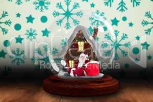 Santa sitting in snow globe