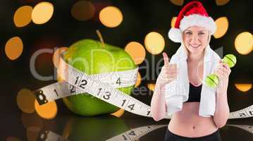 Composite image of festive fit blonde smiling at camera