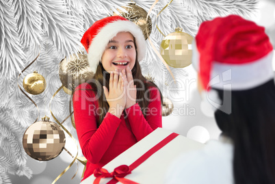 Composite image of little girl getting gift