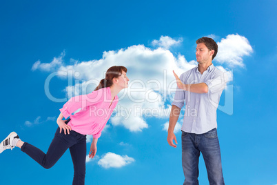 Composite image of man stopping woman from kissing