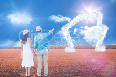 Composite image of happy hipster couple holding hands and lookin