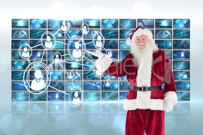 Composite image of santa shows something to camera