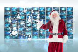 Composite image of santa shows something to camera