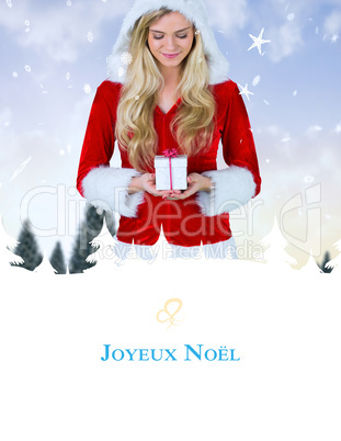 Composite image of pretty girl in santa outfit holding gift